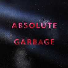 Against a metallic black background, lit by only three beams of light, lies in red letters the title "Absolute Garbage".