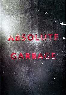 Against a metallic, black, badly lit background lies in red letters the title "Absolute Garbage".