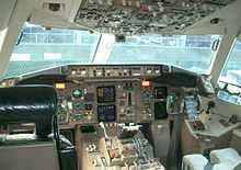 A cockpit of the 767-300ER, which exhibits a hybrid adoption of a new-generation instrument panel and analog gauges and indicators.
