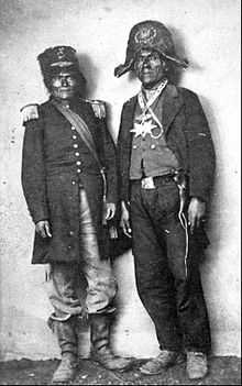 A black and white photograph of two Native Americans