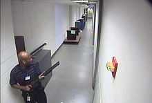 CCTV footage of Aaron Alexis in building 197 holding a Remington 870 shotgun.