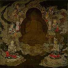 A deity in frontal view surrounded by attendants floating on clouds.