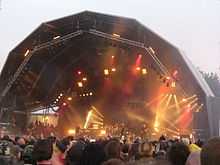 Band on covered stage at outdoor venue