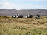 photo of armoured vehicles easy to see on bare hillside