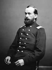 seated man with beard in uniform