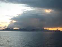 Image of Ascension Island seen from a distance, partly hidden in clouds