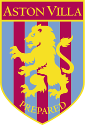 A badge with a yellow border and a yellow lion rampant facing to the left. The background is vertical claret and blue alternating stripes. At the bottom is the motto prepared written in yellow.