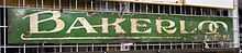 A green metal sign with the words "Bakerloo Tube" on it.