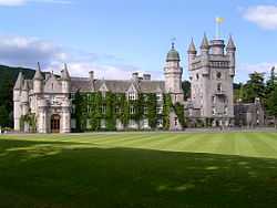 View of Balmoral Castle showing the Royal Banner of Scotland flying from the rooftop flagpole, indicating that Her Majesty The Queen is not in residence.