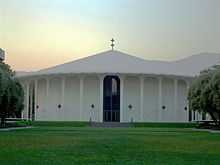 Photo of a  circular building surrounded by grass.