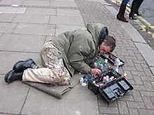 Man lying on pavement, painting chewing gum