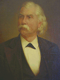 Upper body of a well-dressed man with a white mustache and white hair