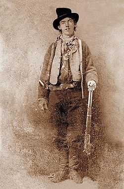 young man with rifle in Old Western garb