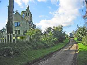 A former church, now converted into a house seen from the east.  At the far end is the preserved tower, with a saddleback roof