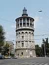 Ground-level view a tower with a circular cross section and a tapering spire