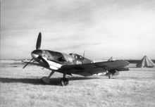 single engine aircraft parked in a field