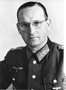 a man in semi profile wearing a military uniform and glasses.