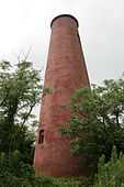 A shorter, conical reddish lighthouse