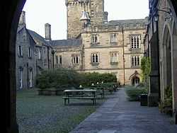 A courtyard with a tower at the far end