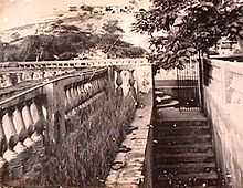 Tinted photo of walls, stairs and open iron gate