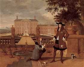 Charles accepts a pineapple from a kneeling man in front of a grand country house