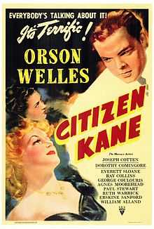 Poster showing two women in the bottom left of the picture looking up towards a man in a white suit in the top right of the picture. "Everybody's talking about it. It's terrific!" appears in the top right of the picture. "Orson Welles" appears in block letters between the women and the man in the white suit. "Citizen Kane" appears in red and yellow block letters tipped 60° to the right. The remaining credits are listed in fine print in the bottom right.