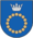 A coat of arms depicting a circle for which the boundary is itself made up of beige circles all under a silver crown on a blue background