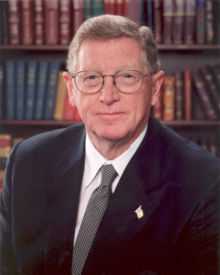 Upper-body portrait of a man in a suit.