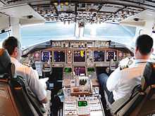 A cockpit of the 767, with multiple liquid crystal display monitors.