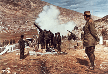 Heavy guns firing, with man in general's uniform standing and observing them to the right