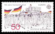Black and white image of the demonstrators at the Hambach festival, carrying flags, depicted on a postage stamp: in the upper left corner, the words 150 Years Hambach Festival commemorate the festival; in the lower right, are the words German postal service.