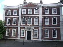 Photograph of the Georgian style hall in three storeys, showing three bays with three windows in the central bay and two windows in each of the lateral bays