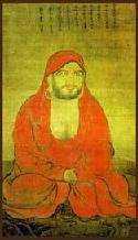 A seated monk in a red robe.