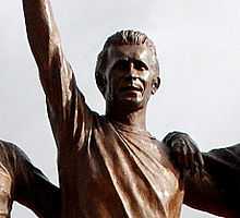 A head and upper shoulders shot of a statue of a footballer