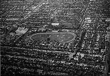 View of numerous houses and streets. In the center is an oval around an open area