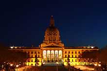 Provincial Legislature of Alberta lit up by exterior lighting during a winter night.
