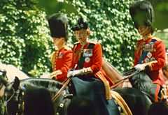 Elizabeth in red uniform on a black horse