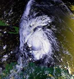 Satellite image of a mature hurricane. The storm features a small, but prominent eye and the whole system covers most of the eastern Caribbean Sea. Haiti can be seen along the edge of a feeder band and eastern Cuba is also visible on the left side of the image.