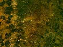 A satellite image of Enugu and other towns that surround it with rivers and hills visible