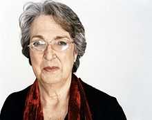 Head and shoulders photograph of a 74 year old woman wearing glasses