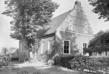 Black and white photo of the building exterior and a tree in 1938