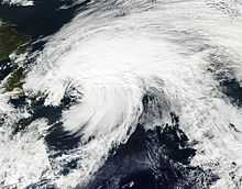 Satellite image of an organized but spread out mass of clouds, in a pattern indicative of rotation.