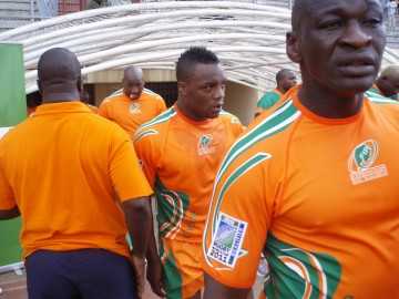 A close up shot of the Ivory Coast players, in their country's orange jerseys, entering the field from the dressing room tunnel.