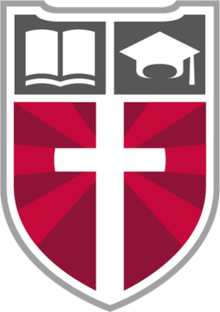 Faith Academy's logo, the "Shield of Faith," displaying a Christian cross and the school's motto.