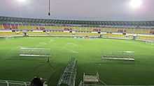 Fatorda Stadium under floodlights and water sprinklers active