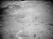 Aerial view of the crater and damage to the surrounding area caused by the explosion.