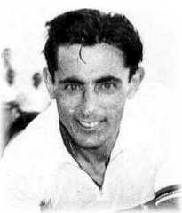 A man in a white shirt, smiling towards the camera