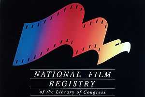 The image includes a logo on a black background. The logo looks like a film reel and changes from left-to-right to an eagle. The logo is multi-colored and below it is the phrase "National Film Registry of the Library of Congress".