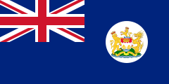 Navy Blue flag with Union Flag as top-left quarter and crest on right side.