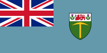 Sky Blue flag with Union Flag as top-left quarter and crest on right side.
